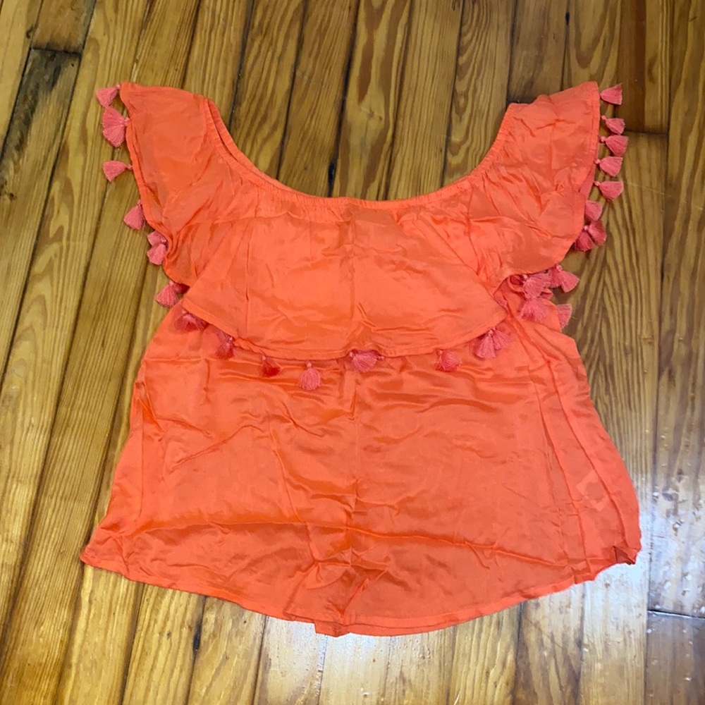 Woman’s off the shoulder top with tassels